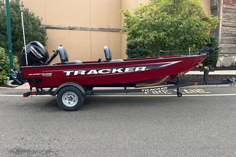 The Image of 2026 Tracker Super Guide V-16 T boat on trailer, parked outdoors. - 0