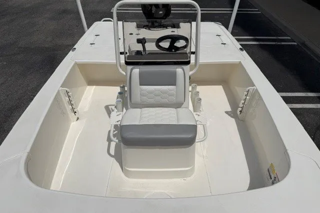 Slide: The Image of 2026 Mako 18 Pro Skiff boat interior with steering console and seating. - 7