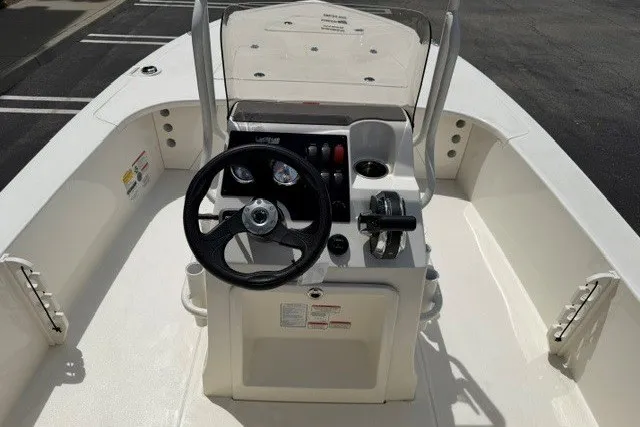 Slide: The Image of 2026 Mako 18 Pro Skiff boat interior with steering console and controls. - 6