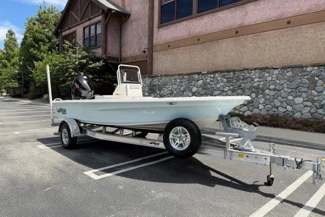 Slide: The Image of 2026 Mako 18 Pro Skiff boat on trailer in parking lot. - 3