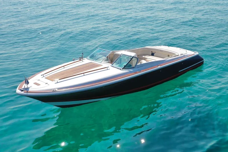 The Image of 2003 Chris-Craft Corsair 28 boat on clear blue water, showcasing sleek design and luxury. - 1