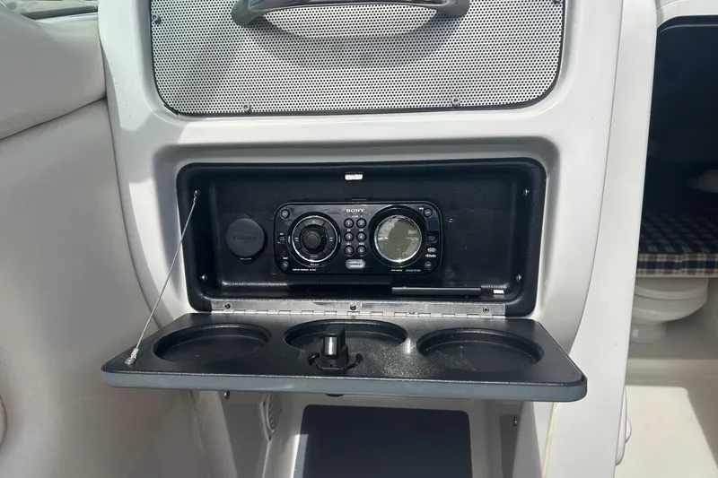 Slide: The Image of 2003 Chris-Craft Corsair 28 boat interior with Sony marine stereo and cup holders. - 10