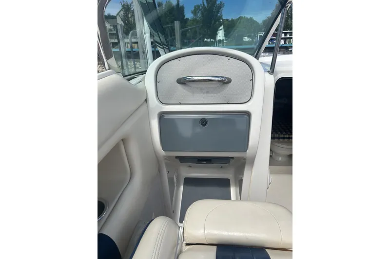 Slide: The Image of 2003 Chris-Craft Corsair 28 interior dashboard with storage compartment and seating. - 11