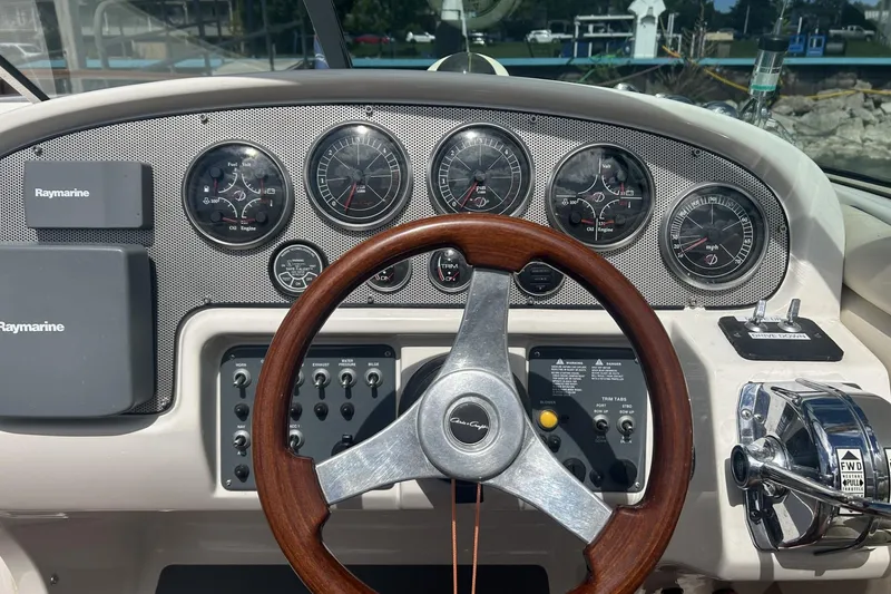 Slide: The Image of Dashboard of a 2003 Chris-Craft Corsair 28 boat with gauges and controls. - 12