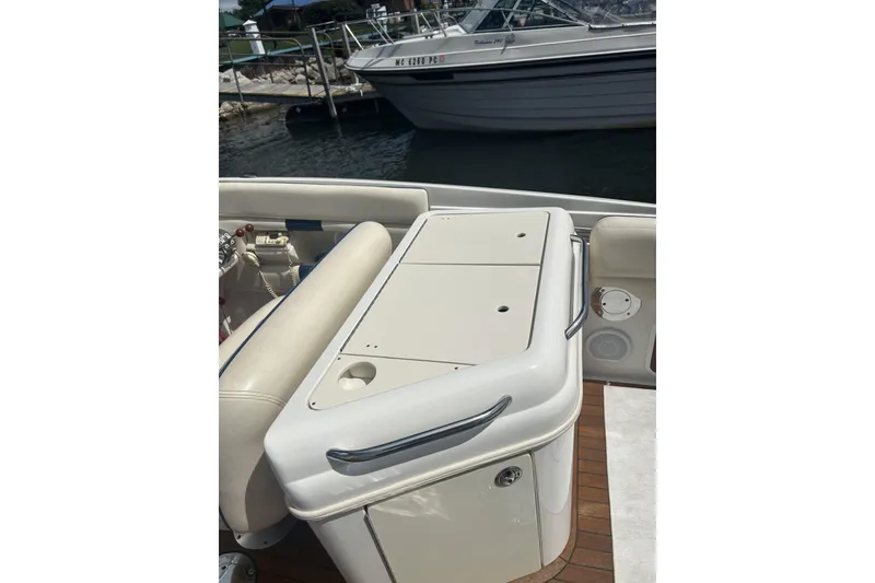 Slide: The Image of 2003 Chris-Craft Corsair 28 boat interior with seating and storage compartment. - 13