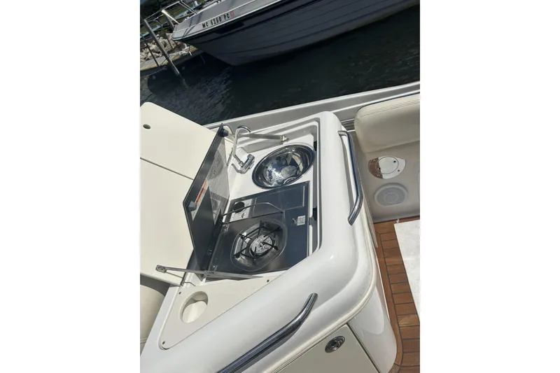 Slide: The Image of 2003 Chris-Craft Corsair 28 boat with onboard kitchen amenities. - 14