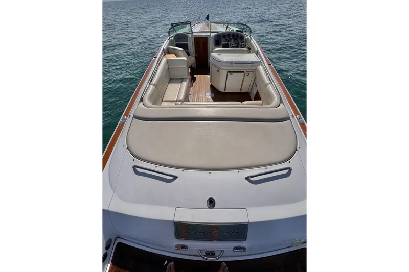 Slide: The Image of 2003 Chris-Craft Corsair 28 boat on water, featuring spacious seating and elegant design. - 3