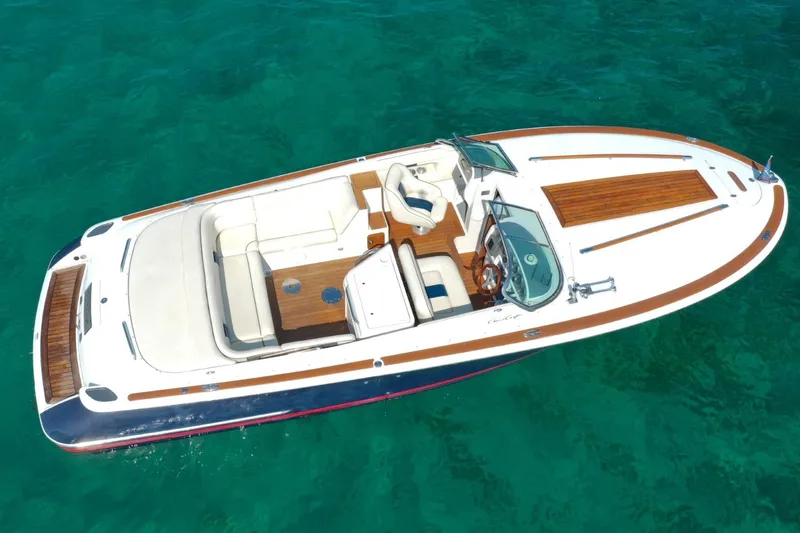 Slide: The Image of 2003 Chris-Craft Corsair 28 boat on clear turquoise water, aerial view. - 4