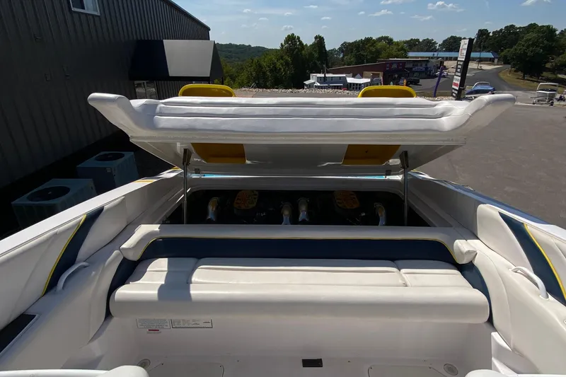 Slide: The Image of 2001 Donzi ZX boat with open engine compartment, showcasing sleek white and blue seating. - 11