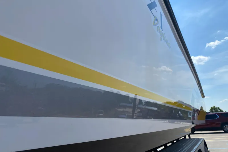 Slide: The Image of 2001 Donzi ZX boat with yellow stripe under clear blue sky. - 20