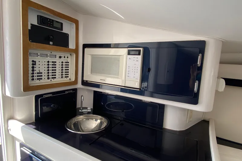 Slide: The Image of 2001 Donzi ZX boat interior with microwave, sink, and control panel. - 24