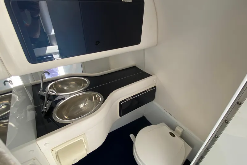 Slide: The Image of 2001 Donzi ZX boat interior bathroom with stainless steel sink and compact toilet. - 25