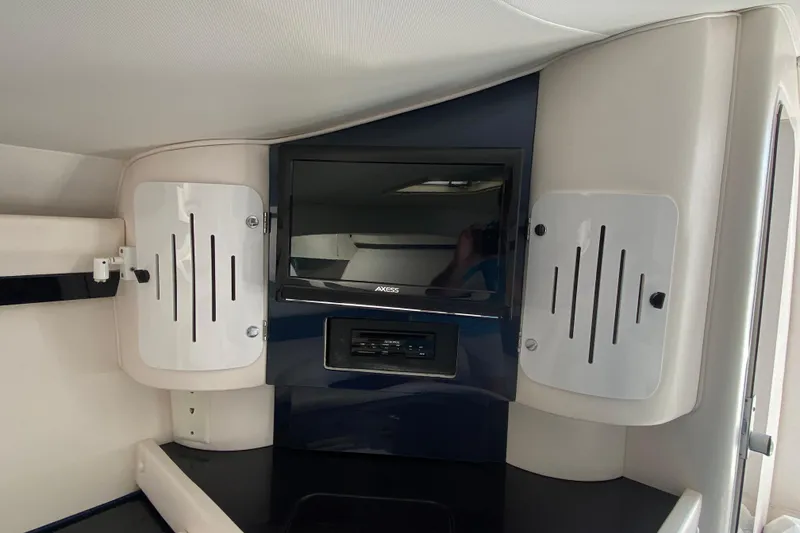 Slide: The Image of Interior of 2001 Donzi ZX boat featuring a mounted TV and speaker system. - 29