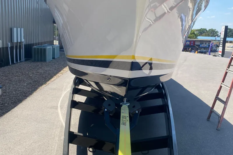 Slide: The Image of 2001 Donzi ZX boat on trailer, viewed from the front, parked outdoors. - 31