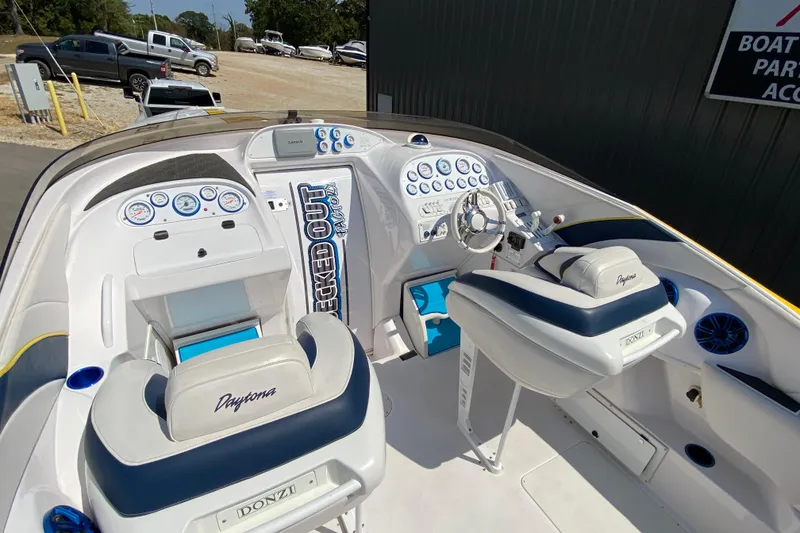 Slide: The Image of 2001 Donzi ZX boat interior with white and blue seating, dashboard, and steering wheel. - 5