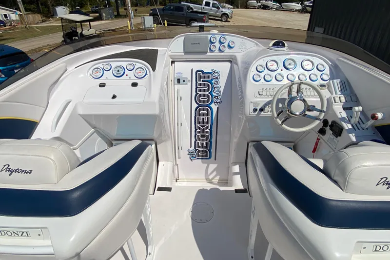 Slide: The Image of 2001 Donzi ZX boat cockpit with dual seats, steering wheel, and control panel. - 6