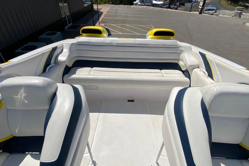 Slide: The Image of 2001 Donzi ZX boat interior with white and blue seating, parked outdoors. - 7
