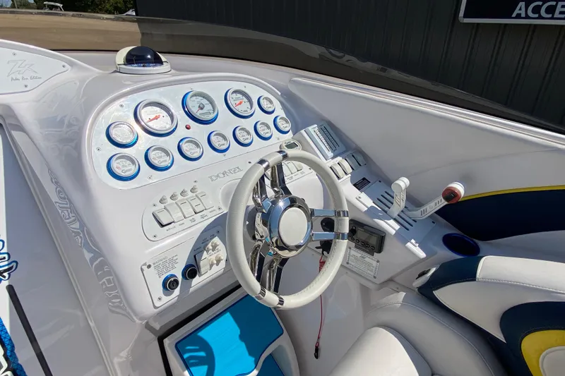 Slide: The Image of 2001 Donzi ZX boat dashboard with gauges, steering wheel, and controls. - 8