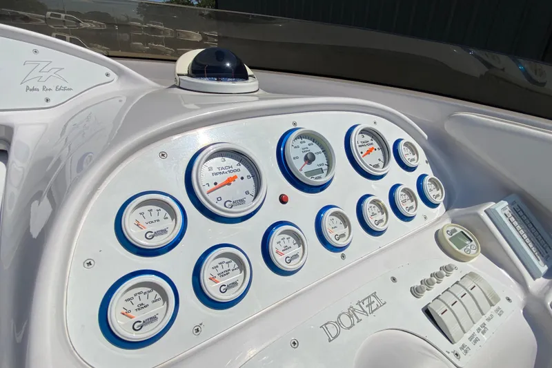 Slide: The Image of Dashboard of a 2001 Donzi ZX boat with gauges and controls. - 9
