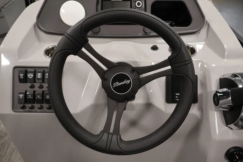 Slide: The Image of Steering wheel of 2026 Bentley Pontoons 203 Bolt Tri-Toon, featuring control panel. - 18