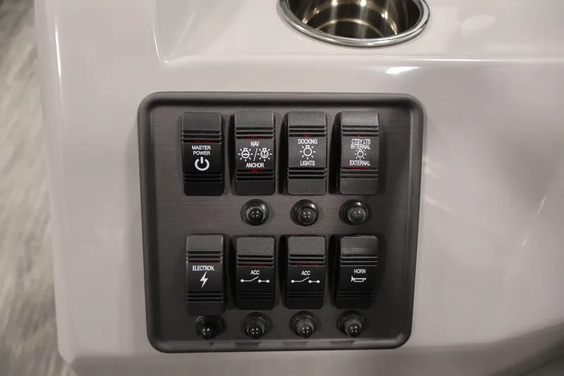 Slide: The Image of Control panel of 2026 Bentley Pontoons 203 Bolt Tri-Toon with various switches. - 21