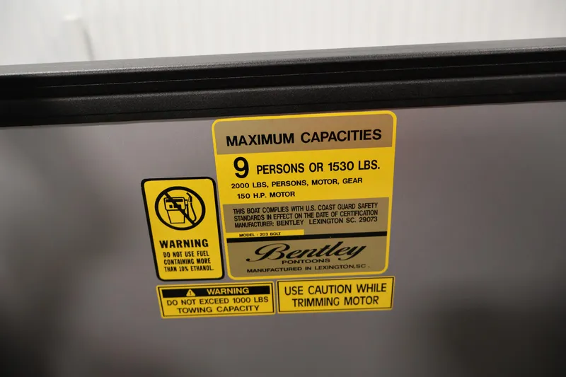 Slide: The Image of Warning label on 2026 Bentley Pontoons 203 Bolt Tri-Toon, detailing capacity and safety instructions. - 23