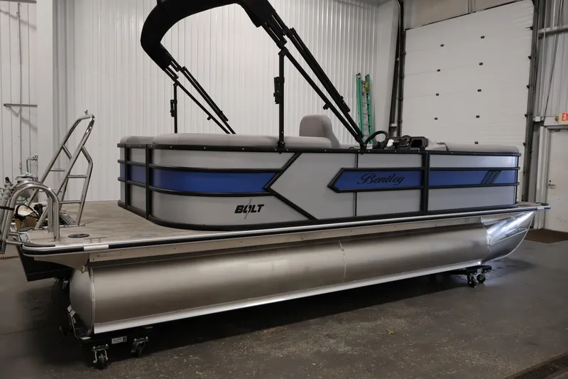 Slide: The Image of 2026 Bentley Pontoons 203 Bolt Tri-Toon in a showroom, featuring sleek design and modern amenities. - 3