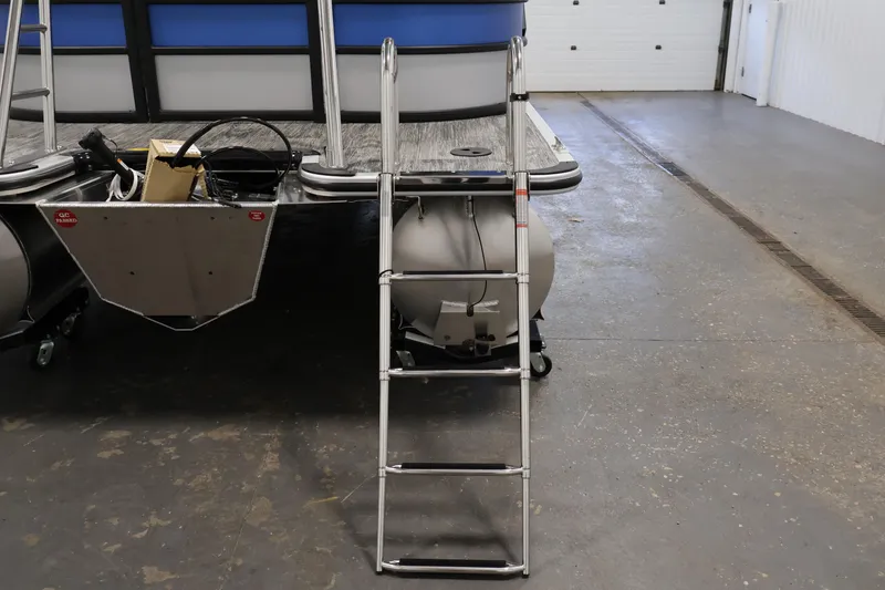 Slide: The Image of 2026 Bentley Pontoons 203 Bolt Tri-Toon with ladder in a garage setting. - 33