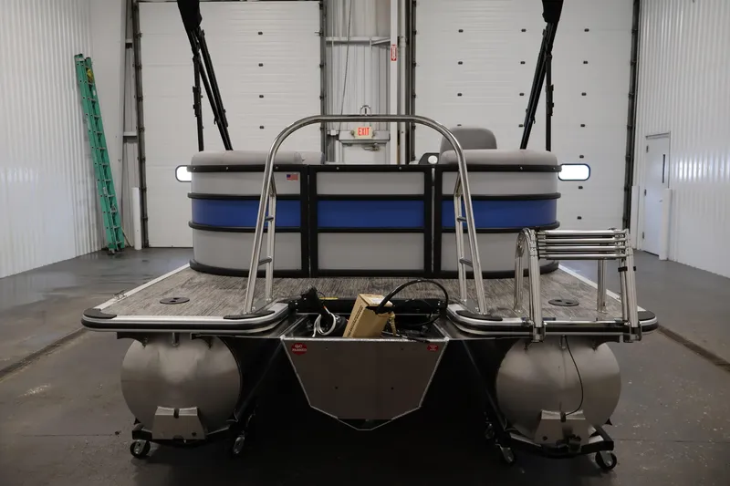 Slide: The Image of 2026 Bentley Pontoons 203 Bolt Tri-Toon in a garage, rear view. - 5