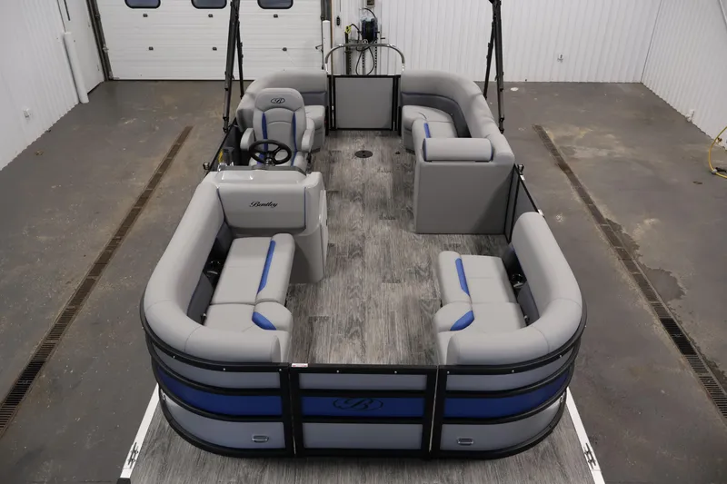 Slide: The Image of 2026 Bentley Pontoons 203 Bolt Tri-Toon with spacious seating in a showroom. - 8