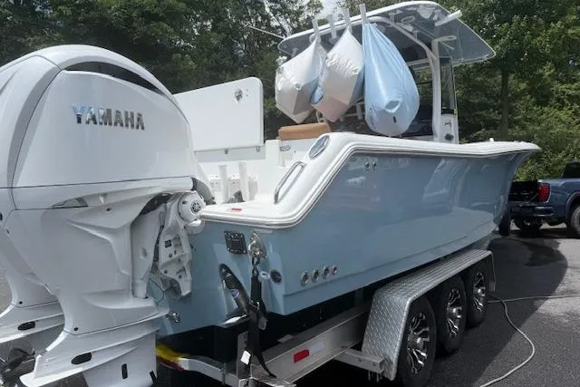 The Image of 2022 Sea Hunt Gamefish 30 on trailer with Yamaha outboard motor, parked outdoors. - 0