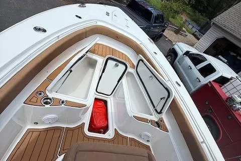 Slide: The Image of 2022 Sea Hunt Gamefish 30 Forward Seating boat with open storage compartments. - 10