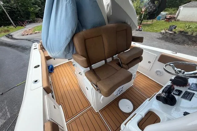 Slide: The Image of 2022 Sea Hunt Gamefish 30 boat with forward seating and brown cushioned helm. - 14