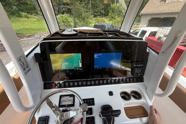 Slide: The Image of 2022 Sea Hunt Gamefish 30 boat dashboard with dual navigation screens and controls. - 3
