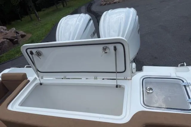 Slide: The Image of 2022 Sea Hunt Gamefish 30 boat with open storage compartment and twin engines. - 5