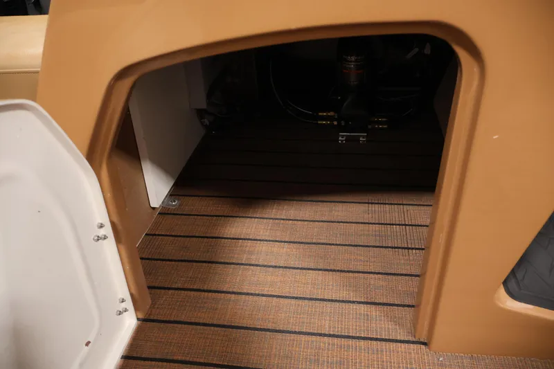 Slide: The Image of 2026 Bentley Pontoons Elite 253 interior with teak-style flooring and storage hatch. - 19