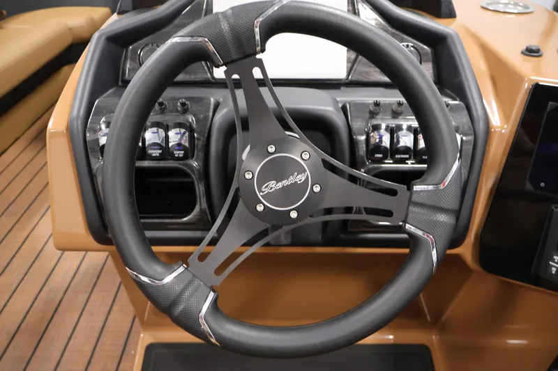 Slide: The Image of 2026 Bentley Pontoons Elite 253 storage compartment on teak-style flooring. - 21