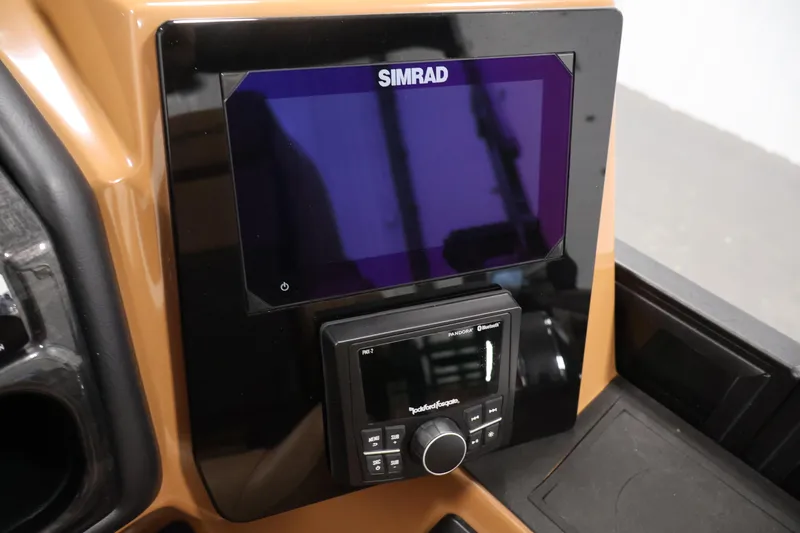 Slide: The Image of 2026 Bentley Pontoons Elite 253 Swingback Tri-Toon with dual captain chairs in a showroom. - 25