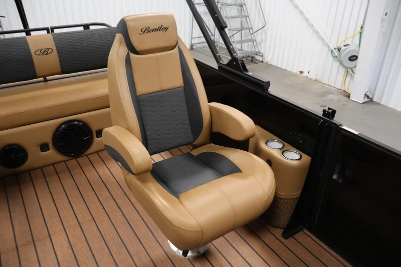Slide: The Image of 2026 Bentley Pontoons Elite 253 Tri-Toon with dual captain chairs, rear view in showroom. - 30