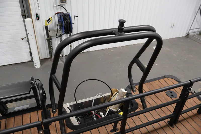 Slide: The Image of 2026 Bentley Pontoons Elite 253 interior with tan seating and wood flooring. - 33