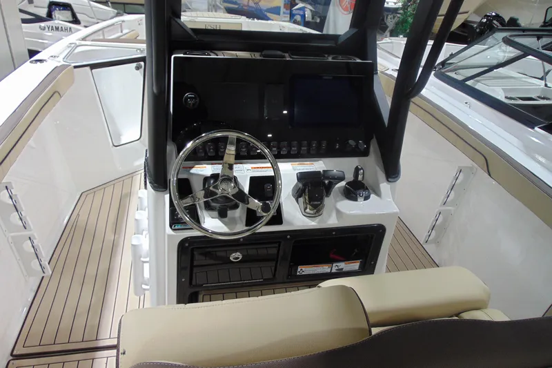 Slide: The Image of 2026 Yamaha Boats 255 FSH Sport H dashboard with steering wheel and controls. - 11