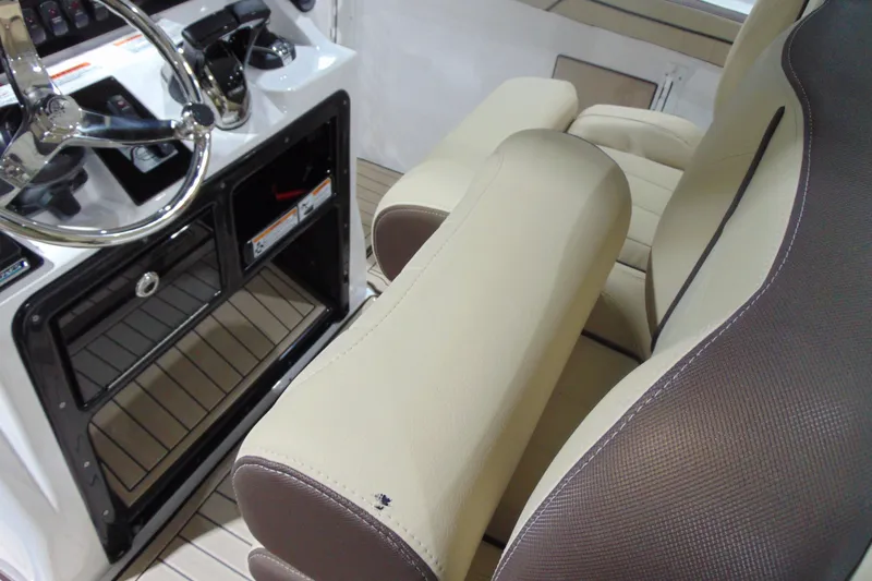 Slide: The Image of Interior of 2026 Yamaha Boats 255 FSH Sport H, featuring steering wheel and seating. - 12