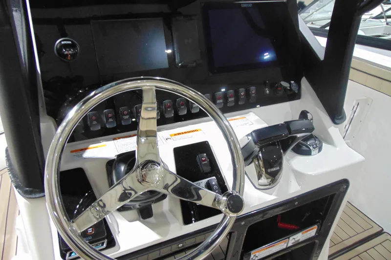 Slide: The Image of 2026 Yamaha Boats 255 FSH Sport H dashboard with steering wheel and controls. - 13