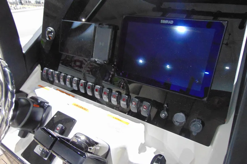 Slide: The Image of Control panel of 2026 Yamaha Boats 255 FSH Sport H with Simrad display and switches. - 15