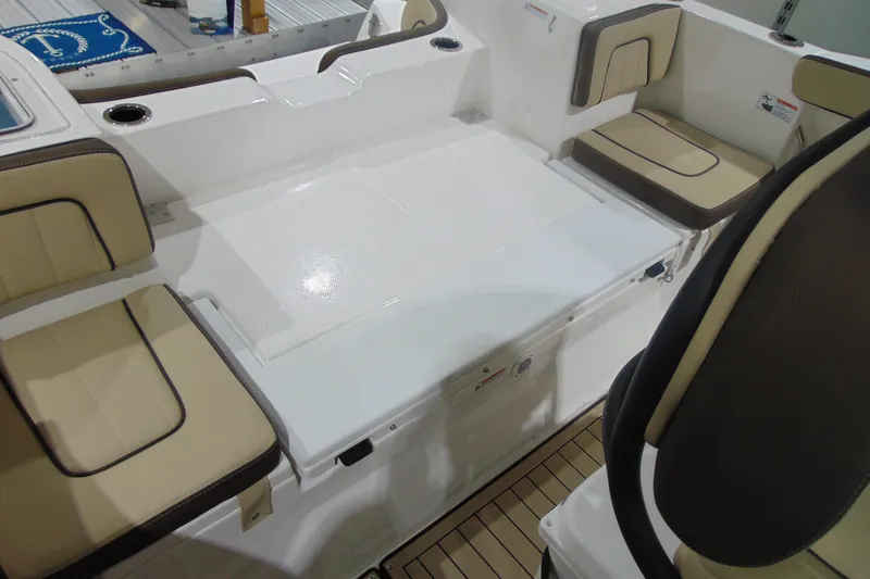 Slide: The Image of 2026 Yamaha Boats 255 FSH Sport H interior seating with beige cushions and white deck. - 17