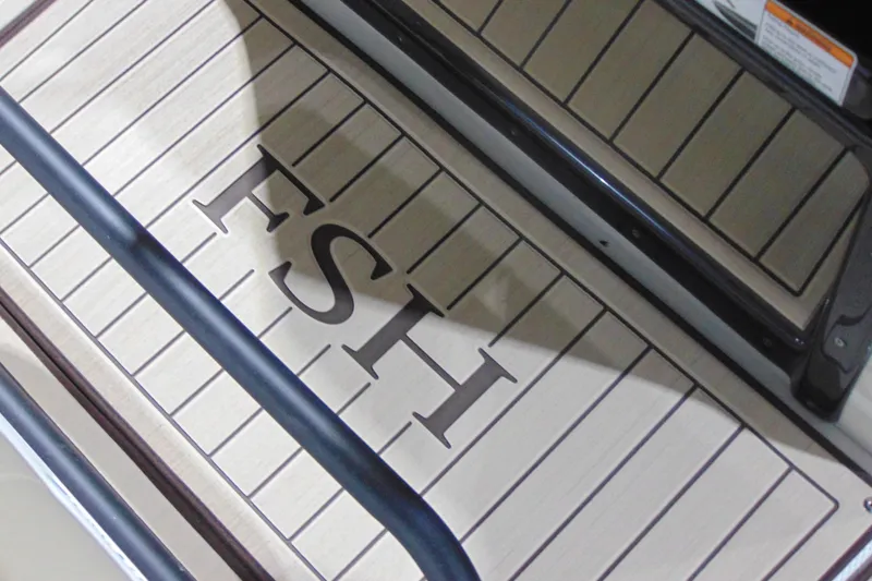 Slide: The Image of Yamaha Boats 2026 255 FSH Sport H deck with 'FSH' lettering, showcasing sleek design. - 19