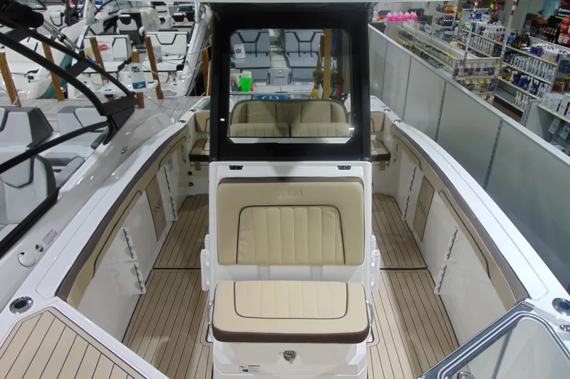 Slide: The Image of 2026 Yamaha Boats 255 FSH Sport H interior with beige seating and sleek design. - 24