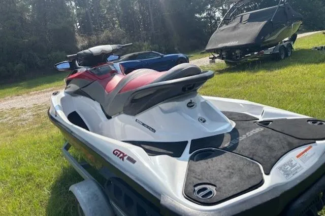 Slide: The Image of 2010 Sea-Doo GTX 155 jet ski on grass, showcasing sleek design and vibrant colors. - 11
