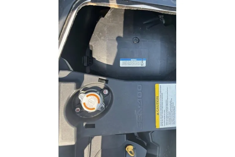Slide: The Image of 2010 Sea-Doo GTX 155 engine compartment with caution label and cap. - 17