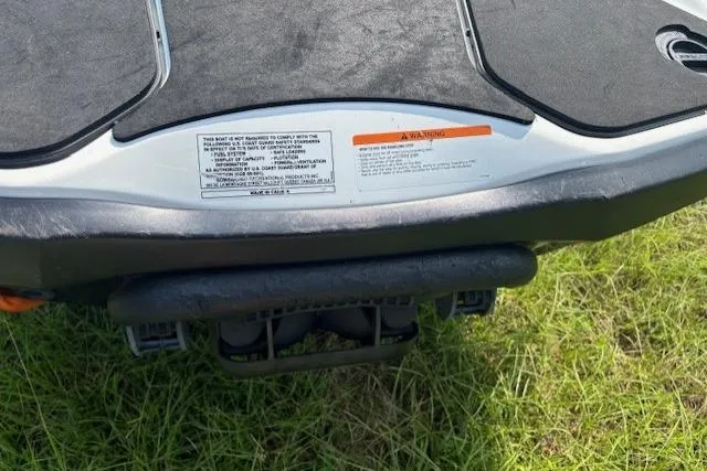 Slide: The Image of 2010 Sea-Doo GTX 155 rear view on grass, showing warning label and platform. - 18